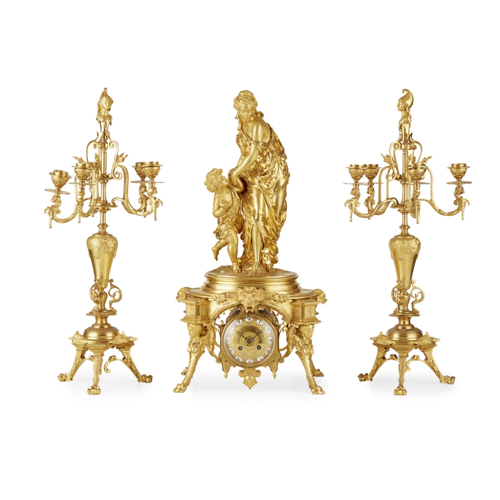 A NAPOLEON III ORMOLU THREE PIECE CLOCK GARNITURE The group after a model by Emile Herbert, the