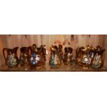 A COLLECTION OF TEN 19TH CENTURY COPPER LUSTRE POTTERY JUGS Two sets of five matching jugs with
