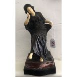 AN EARLY/MID 20TH CENTURY BRONZE AND IVORINE STATUE Seated Romanesque female in thoughtful pose,