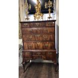 AN 18TH CENTURY WALNUT CHEST ON STAND Fitted with an arrangement of nine drawers, all with brass