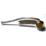 A STERLING SILVER BOSUN'S WHISTLE Having gold plated embossed British Naval insignia. (approx 10cm)