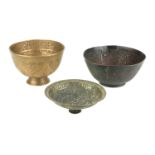 THREE 17TH CENTURY INDIAN DAKAN BEGGING BOWLS With engraved decoration. (largest 7.5cm)
