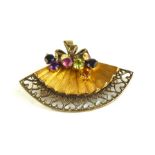 AN UNUSUAL 9CT GOLD AND GEM SET TUTTI FRUITTI FAN BROOCH Having a wide wire work pierced border