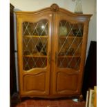 AN EARLY/MID 20TH CENTURY DUTCH OAK BOOKCASE With shaped cornice above glazed and panelled doors, on