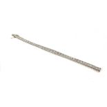 AN 18CT WHITE GOLD AND DIAMOND BRACELET The single row of round cut graduating diamonds. (approx