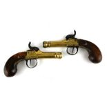 A PAIR OF EARLY 19TH CENTURY BRASS AND WALNUT PISTOLS Percussion cap with engraved decoration and