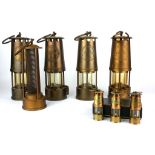 A COLLECTION OF FOUR EARLY 20TH CENTURY BRASS 'DAVY' MINERS LAMPS Marked 'Protector Lamps and