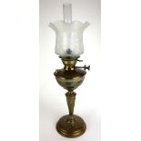 A VICTORIAN BRASS GLASS OIL LAMP Having a frosted and etched glass shade, embossed organic form