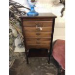 AN EDWARDIAN MAHOGANY MUSIC CABINET Bank of five drawers with open shelf below.