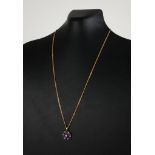 A 9CT GOLD, AMETHYST AND SEED PEARL PENDANT NECKLACE Having an arrangement of oval cut amethyst