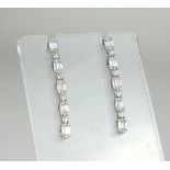AN 18CT WHITE GOLD AND DIAMOND DROP EARRINGS Each set with five baguette diamonds interspersed