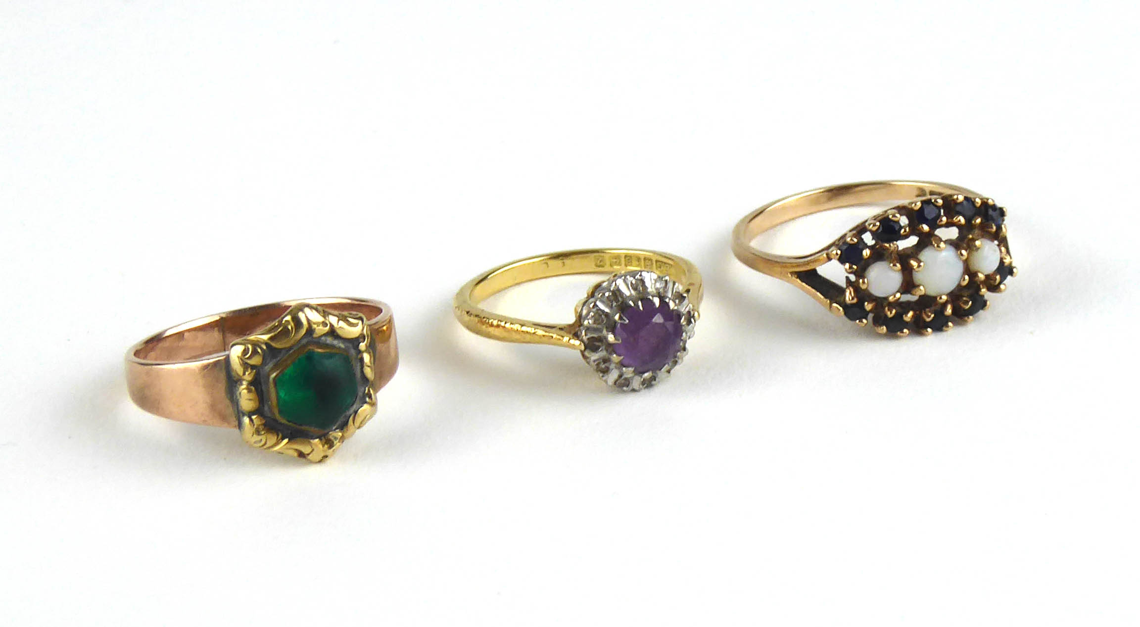 A VINTAGE 18CT GOLD, AMETHYST AND DIAMOND RING The round cut amethyst edged with diamonds,