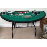 A FOLDING BLACKJACK TABLE Complete with chips and cards. (168cm x 85cm x 76cm)