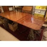 A 19TH CENTURY MAHOGANY TRIPLE PILLAR DINING TABLE With tilting action, and two extra leaves, raised