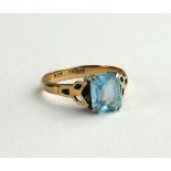 A VINTAGE 9CT GOLD AND AQUAMARINE RING Having a baguette cut stone in pierced mount (size K).