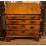 AN 18TH CENTURY WALNUT WRITING BUREAU The fall front enclosing a fitted interior above four