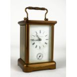 MATHEW NORMAN, A 20TH CENTURY GILT BRASS CARRIAGE CLOCK Having a brass carry handle, four bevelled