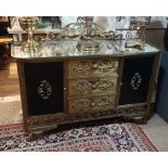 A MID 20TH CENTURY CONTINENTAL SIDE CABINET With floral cartouche above mirrored top and three brass
