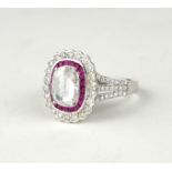 AN 18CT WHITE GOLD 1.53CT ROSE CUT DIAMOND AND RUBY RING Having a single oval rose cut stone edged
