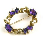 AN EARLY 20TH CENTURY 9CT GOLD, AMETHYST AND SEED PEARL BROOCH Having two pairs of pear cut