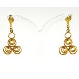 A PAIR OF YELLOW METAL EARRINGS The arrangement of three spirals with stud backs. (approx 2.