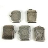 A COLLECTION OF FIVE VICTORIAN AND LATER SILVER RECTANGULAR VESTA CASES With engraved decoration,