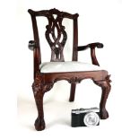 A MINIATURE CHIPPENDALE DESIGN MAHOGANY OPEN ARMCHAIR With shaped and scroll back rail above a