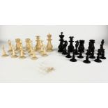 A VICTORIAN NATURAL AND EBONISED IVORY CHESS SET Having traditional form turned pieces with