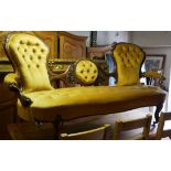 A VICTORIAN WALNUT THREE SEAT SPOON BACK SETTEE Button back mustard upholstery, along with matched