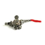 A VICTORIAN SILVER AND CORAL CHILD'S RATTLE Having a whistle finial and a row of whistles and