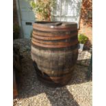 A LARGE EARLY 20TH CENTURY IRON BOUND COOPERED BARREL. (80cm x 110cm)