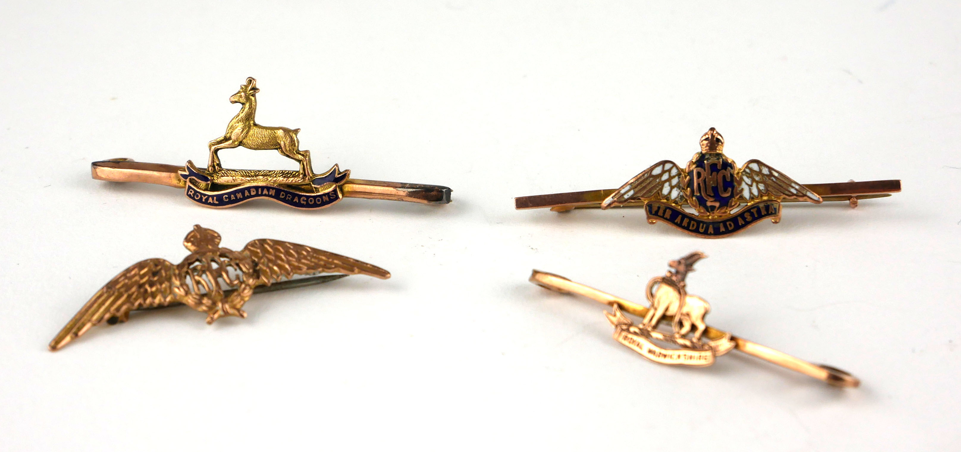 A COLLECTION OF FOUR EARLY 20TH CENTURY 9CT GOLD SWEETHEART BROOCHES Two Royal Flying Corps, one