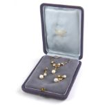 A VINTAGE 18CT GOLD, DIAMOND AND PEARL NECKLACE AND EARRINGS SET The arrangement of graduated pearls
