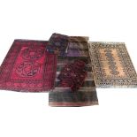 THREE SADDLE BAGS Along with two small rugs. (largest 88cm x 100cm)