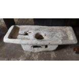 AN INDONESIAN CARVED TEAK RECTANGULAR RICE POUNDING TABLE With concave well to centre. (approx