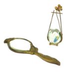 AN ART NOUVEAU GILT BRONZE HAND MIRROR Having an organic form frame with bevelled glass and oak