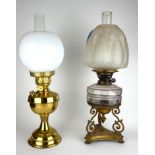 A VICTORIAN BRASS AND FROSTED GLASS OIL LAMP Having an embossed glass shade, faceted glass well