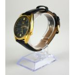 SEIKO, AUTOMATIC, A VINTAGE GOLD PLATED GENT'S WRISTWATCH Having a circular black dial with calendar