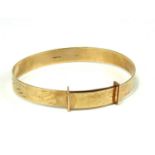 A VINTAGE 9CT GOLD CHILD'S BANGLE Having fine scrolled engraving. (approx diameter 5cm) (approx 6g)