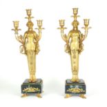 A PAIR OF EMPIRE STYLE GILT BRONZE FIGURAL THREE BRANCH CANDELABRAS On green marble base, raised