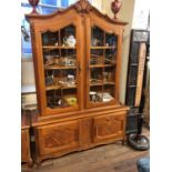 AN EARLY MID 20TH CENTURY DUTCH OAK BOOKCASE/DISPLAY CABINET The shaped pediment centred with a