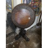 A 19TH CENTURY BURMESE TEAK CENTRE TABLE The circular top with heavily carved and pierced apron,