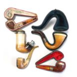 A COLLECTION OF FIVE VICTORIAN AND LATER PIPES To include silver banded meerschaum and amber,