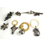 A COLLECTION OF THREE EDWARDIAN WHITE METAL AND IVORY TEETHING RINGS Comprising a squirrel, a