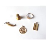 A MIXED LOT OF GOLD CHARMS Together with a gold plated signet ring, four gold charms include a