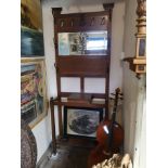 AN ARTS AND CRAFTS PERIOD AND DESIGN OAK HALL STAND With bevelled mirror, central glove box and