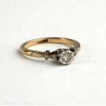 A VINTAGE 9CT GOLD AND DIAMOND SOLITAIRE RING Having a single illusion set round cut diamond (size