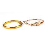 A VICTORIAN 9CT GOLD KNOTT BANGLE Having scrolled design, together with a rolled gold bangle with