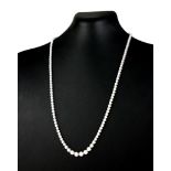 AN 18CT WHITE GOLD AND DIAMOND NECKLACE The single row of round cut graduated stones. (approx