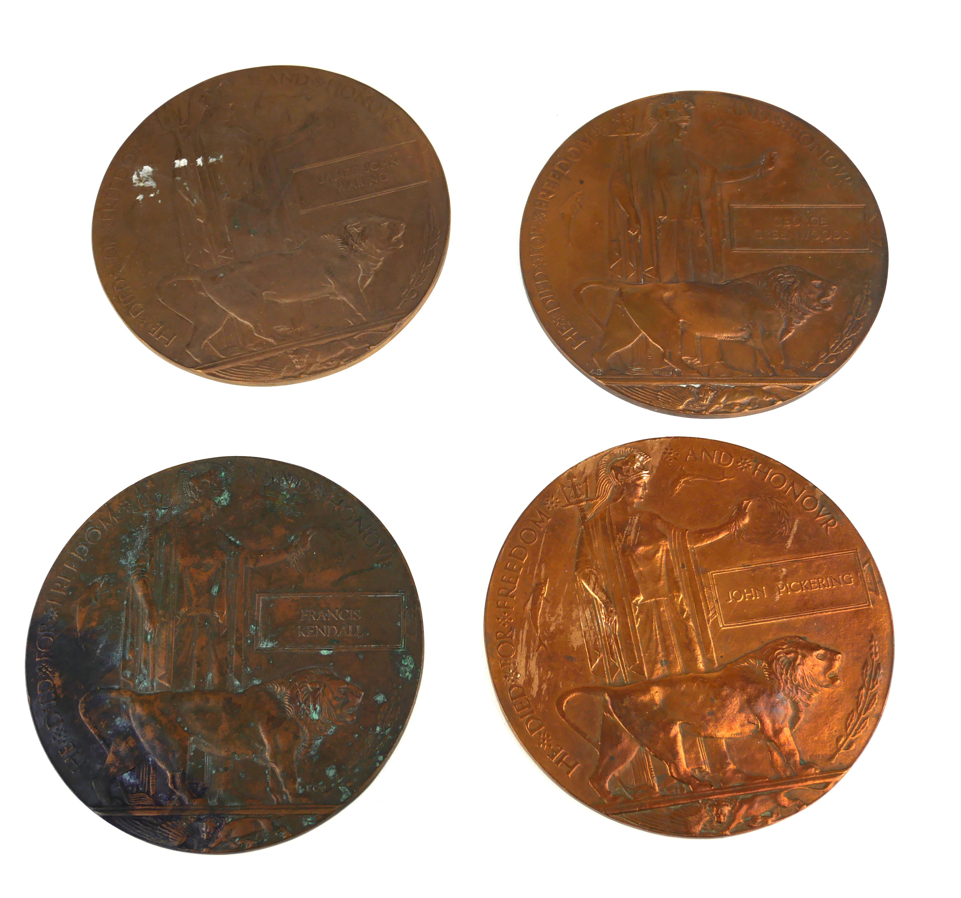 A COLLECTION OF FOUR BRONZE WWI BRITTANIA MEMORIAL PLAQUES To commemorate John Pickering, James John